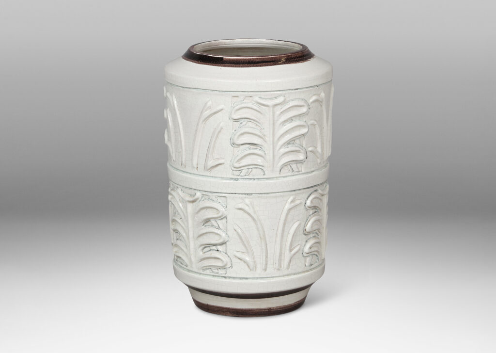 Gallery BAC cylindrical form with relief palmette pattern, glazed in an ivory craquel with black edges