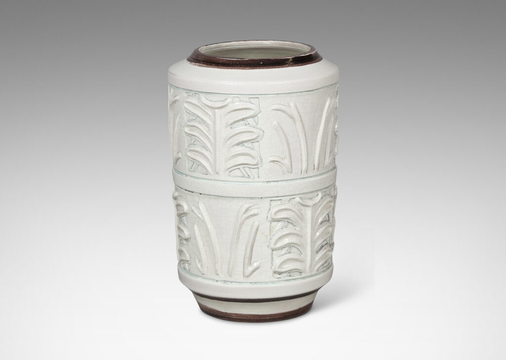 Gallery BAC cylindrical form with relief palmette pattern, glazed in an ivory craquel with black edges
