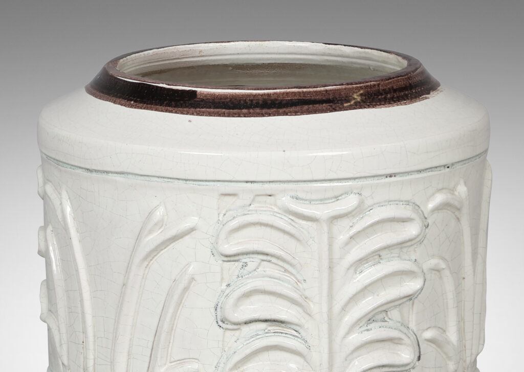 Gallery BAC cylindrical form with relief palmette pattern, glazed in an ivory craquel with black edges