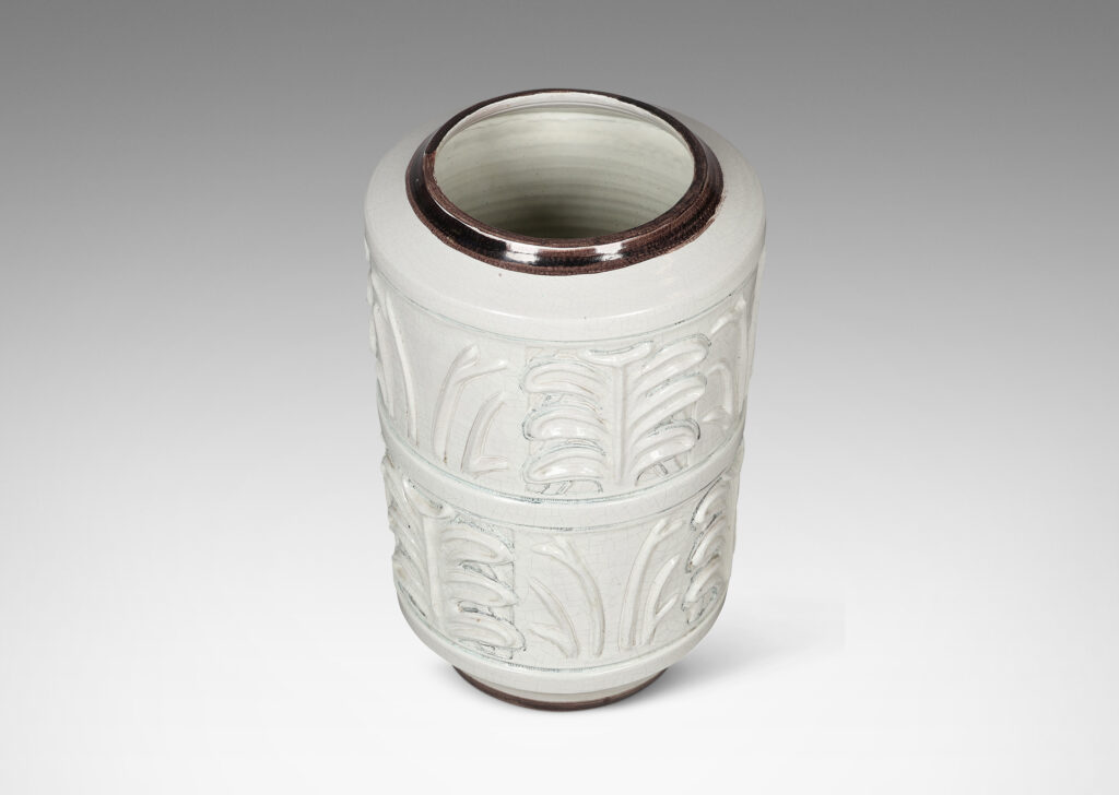 Gallery BAC cylindrical form with relief palmette pattern, glazed in an ivory craquel with black edges