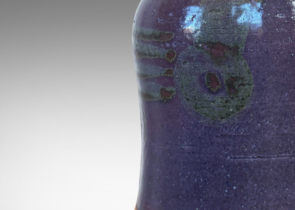 Gallery BAC substantial bell form glazed in burgundy oxblood with tassel design in gray-purple