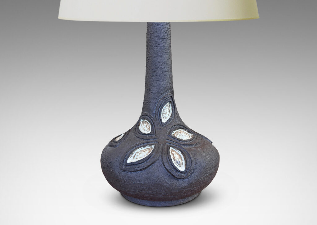Gallery BAC compressed globe body and tall sprouting neck, ornamented with abstracted leaf-flower forms in relief, glazed in matte brown with pale gray accents
