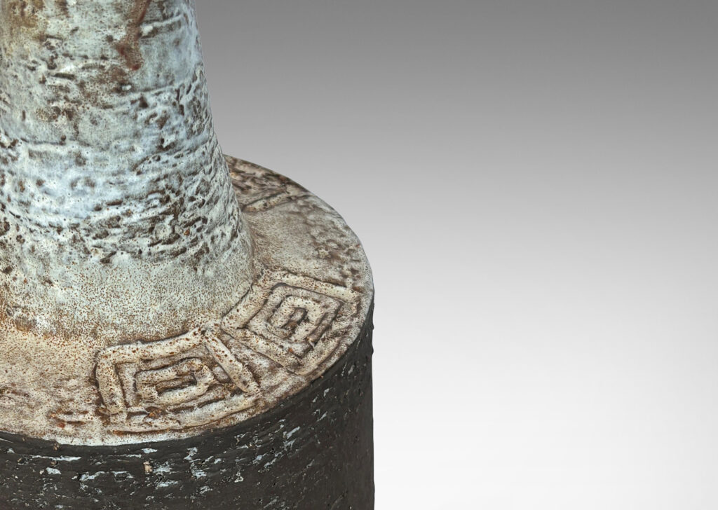 Gallery BAC rakd cylindrical form, with carved Greek key motifs and sprouting neck, glazed in matte brown and white