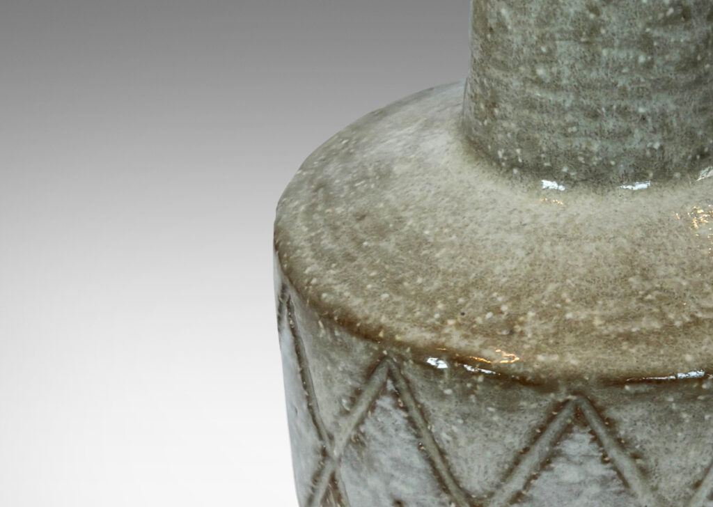 Gallery BAC drum form encircled with carved diamonds and tall conical neck, glazed in pale taupe and white