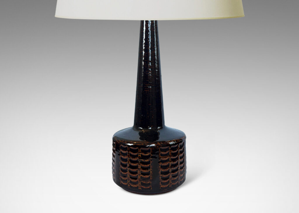 Gallery BAC drum form encircled with grids of carved arc divots and tall conical neck, glazed in a shiny dark brown