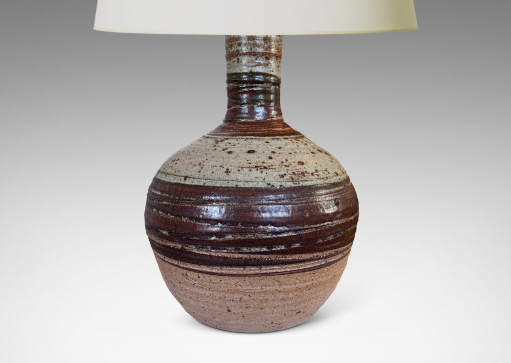 Gallery BAC spherical form with flared neck, partially glazed in dark brown and pale gray, with carved sgraffito spirals