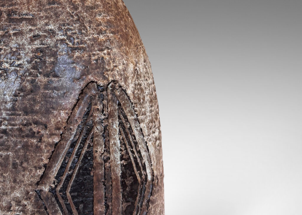 Gallery BAC bell form with carved triangular motifs, glazed in pale gray-tan and brown