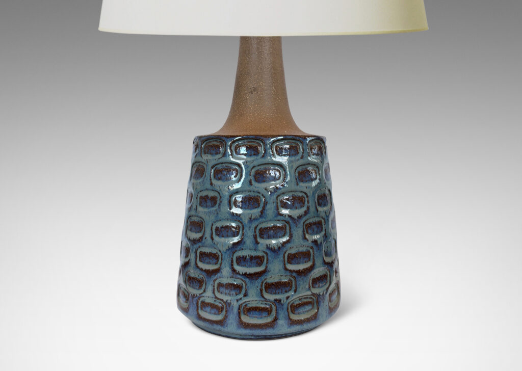 Gallery BAC raked cylinder form with impressed ovoid design and sprouting neck, partially glazed in a flowing icy pale blue