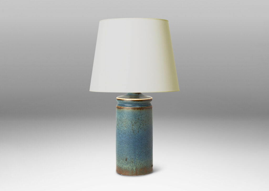 Gallery BAC cylindrical forms with exotic capped tops, glazed in a soft blue with brown