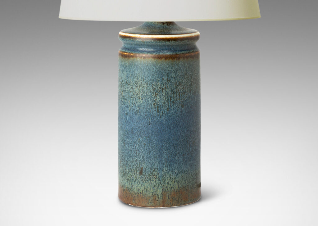 Gallery BAC cylindrical forms with exotic capped tops, glazed in a soft blue with brown