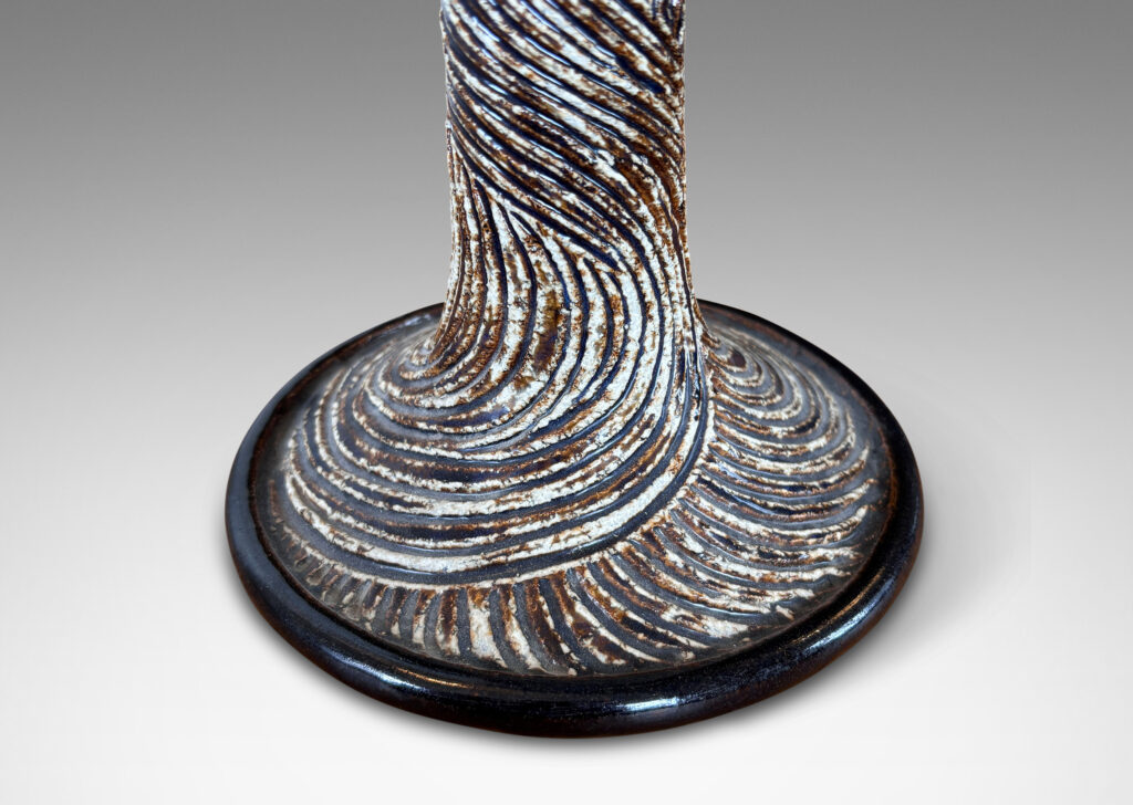 Gallery BAC flared trumpet form, carved with energetic swirling lines, glazed in brown and ivory