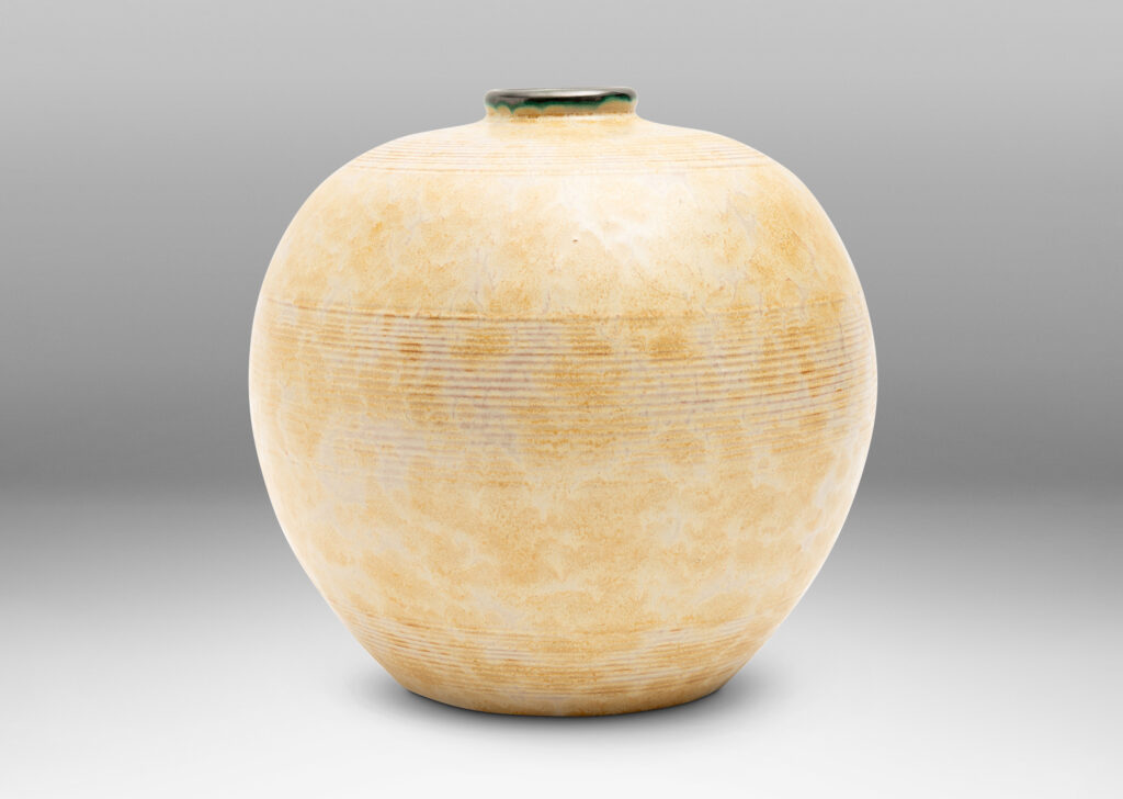 Gallery BAC wide globe form with bands of relief ridges glazed in a pale ochre-buff