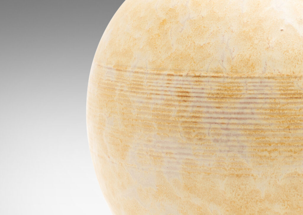 Gallery BAC wide globe form with bands of relief ridges glazed in a pale ochre-buff