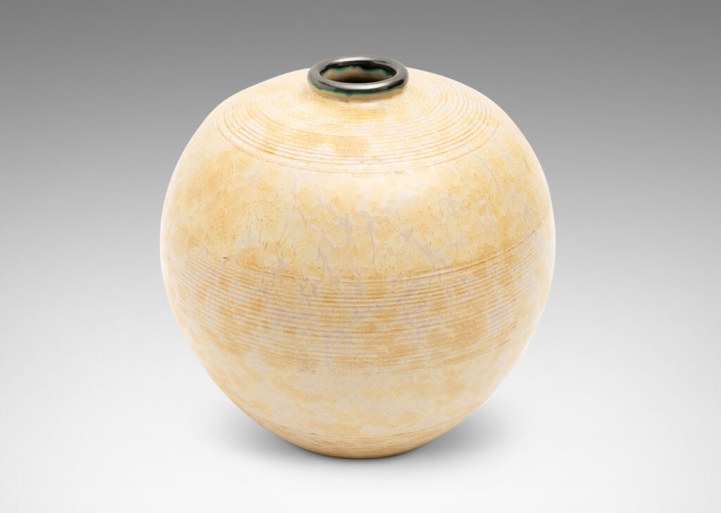 Gallery BAC wide globe form with bands of relief ridges glazed in a pale ochre-buff