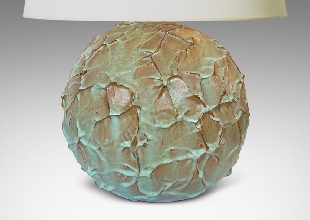 Gallery BAC highly textured globe form in a bright celadon glaze with brown tinted edges from the underlying ceramic