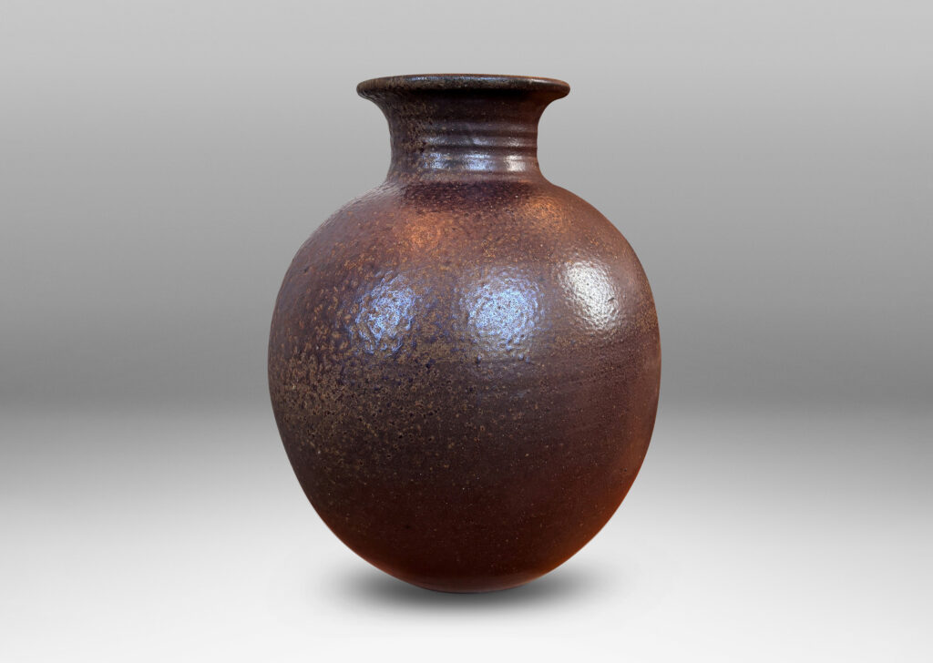Gallery BAC globe form with wide neck and flared mouth in a dark brown salt glaze