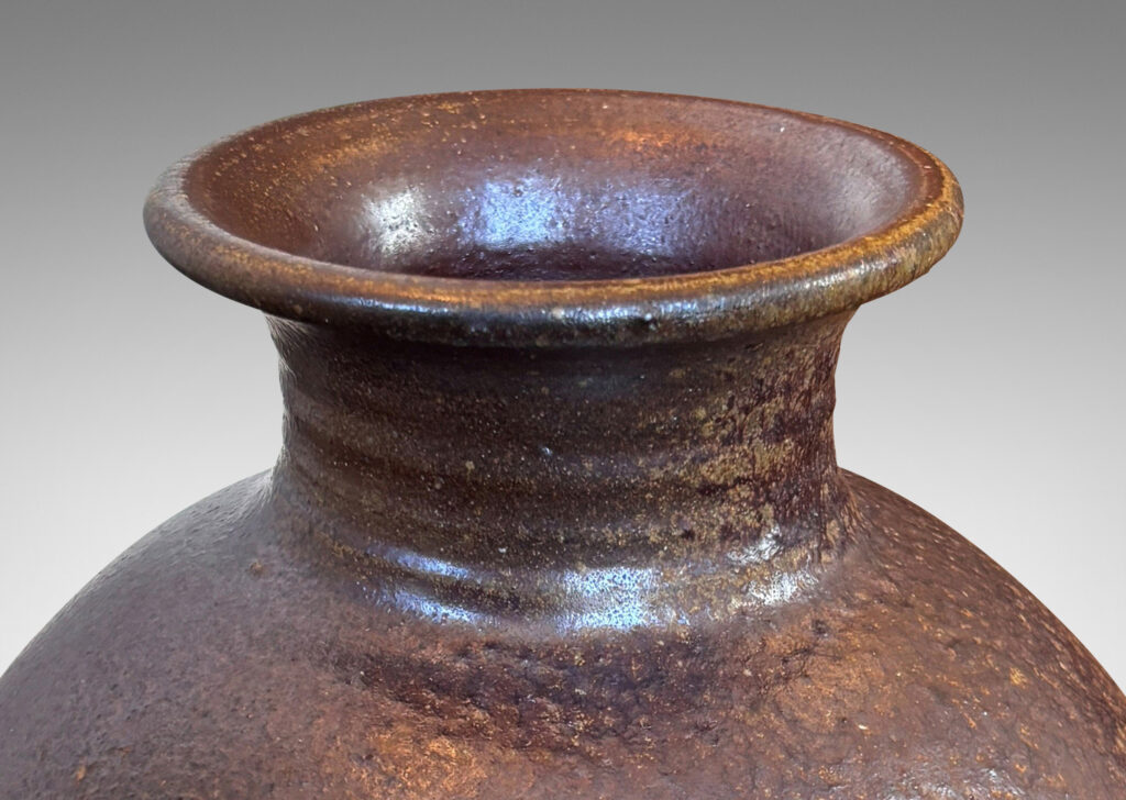 Gallery BAC globe form with wide neck and flared mouth in a dark brown salt glaze