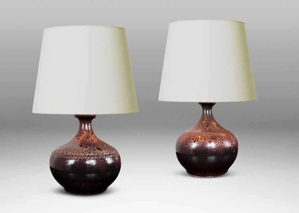 Gallery BAC low wide bulbous form with relief ring of dots; glazed in dark brown with a frothy effect on shoulders