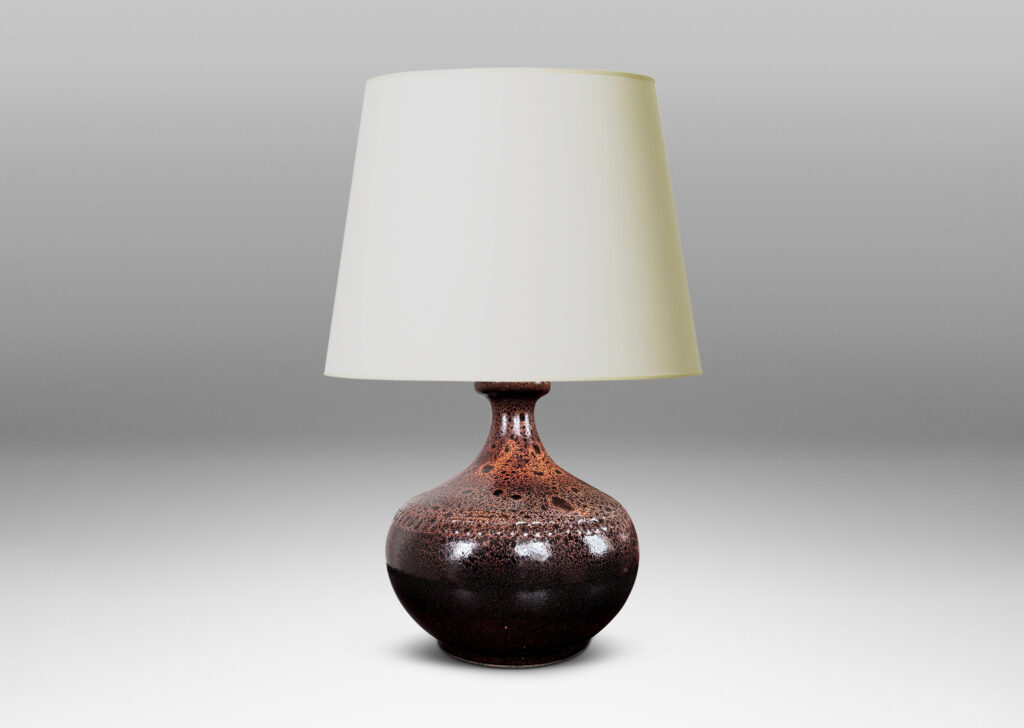 Gallery BAC low wide bulbous form with relief ring of dots; glazed in dark brown with a frothy effect on shoulders