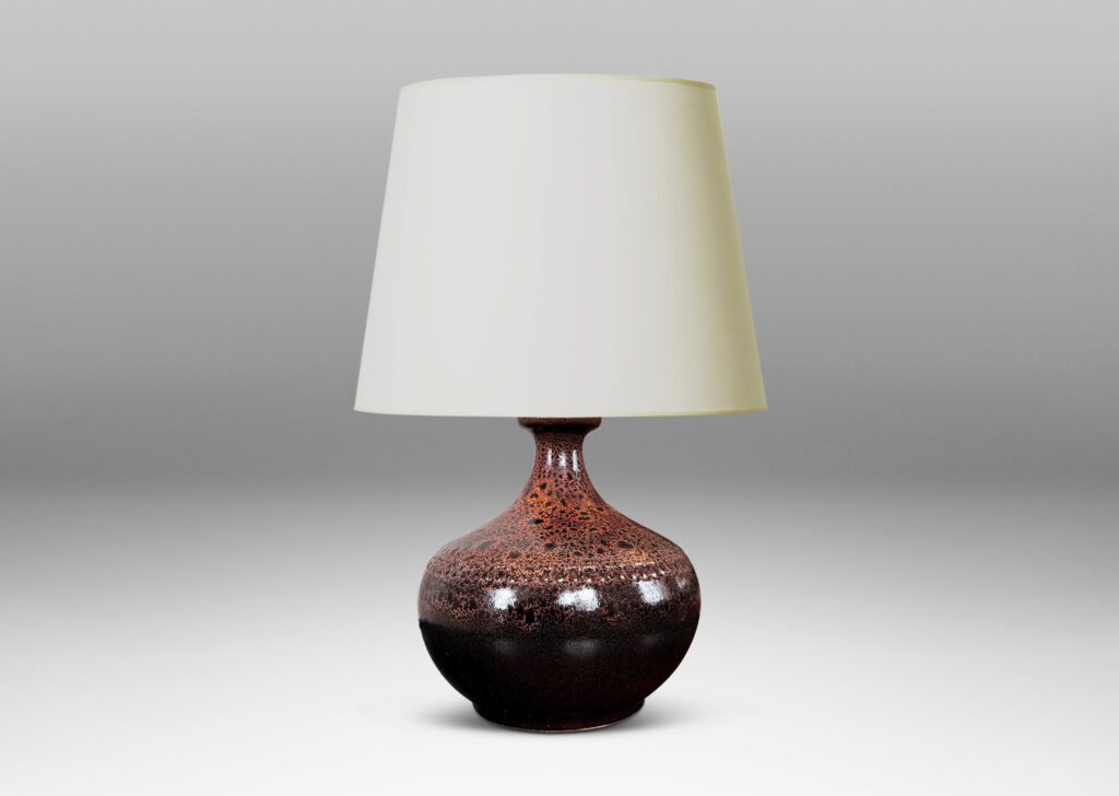 Gallery BAC low wide bulbous form with relief ring of dots; glazed in dark brown with a frothy effect on shoulders