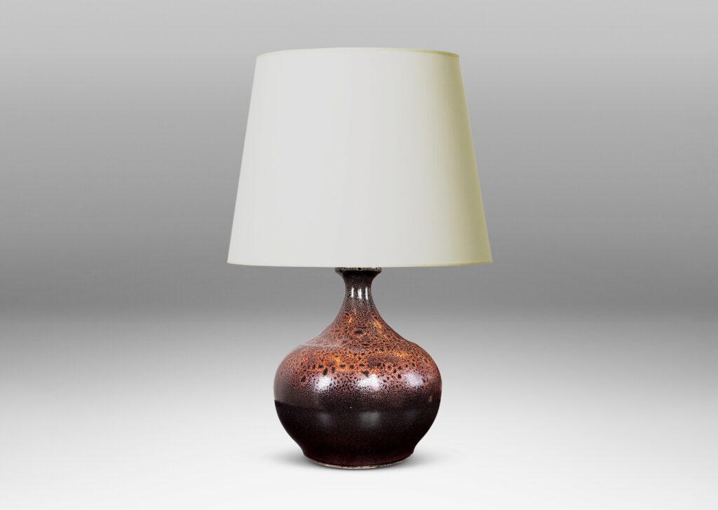 Gallery BAC low wide bulbous form with relief ring of dots; glazed in dark brown with a frothy effect on shoulders