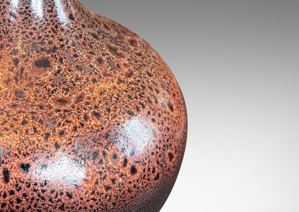 Gallery BAC low wide bulbous form with relief ring of dots; glazed in dark brown with a frothy effect on shoulders