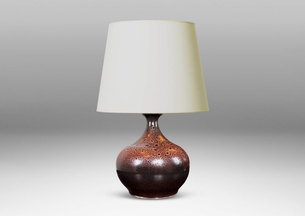 Gallery BAC low wide bulbous form with relief ring of dots; glazed in dark brown with a frothy effect on shoulders