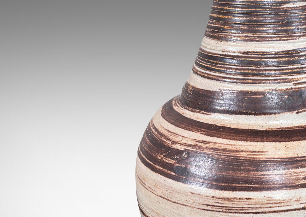 Gallery BAC compressed globe and tall thick neck, with ridged surface, glazed in light gray with brown spiral