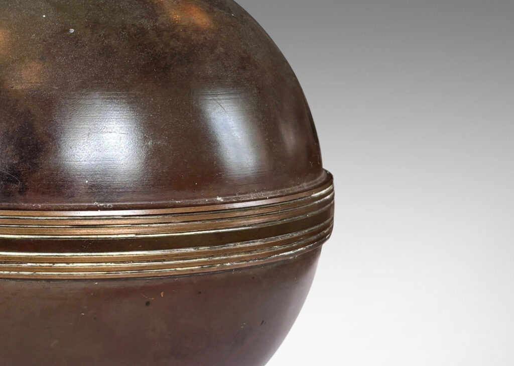 Gallery BAC spherical form with relief engraved equatorial band and a square plinth, with a rich antique patination