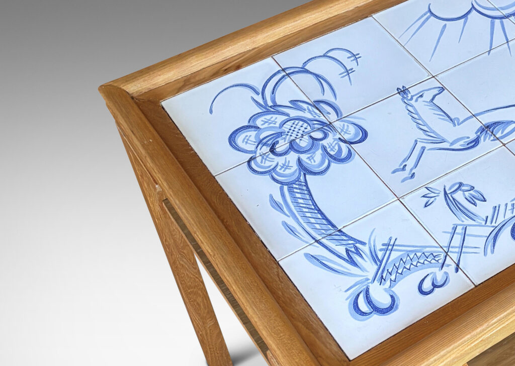 Gallery BAC rectangular top with sculpted lip, tapered legs and shelf, featuring a tile top surface in white glaze with charming hand-painted deer and landscape design in blue