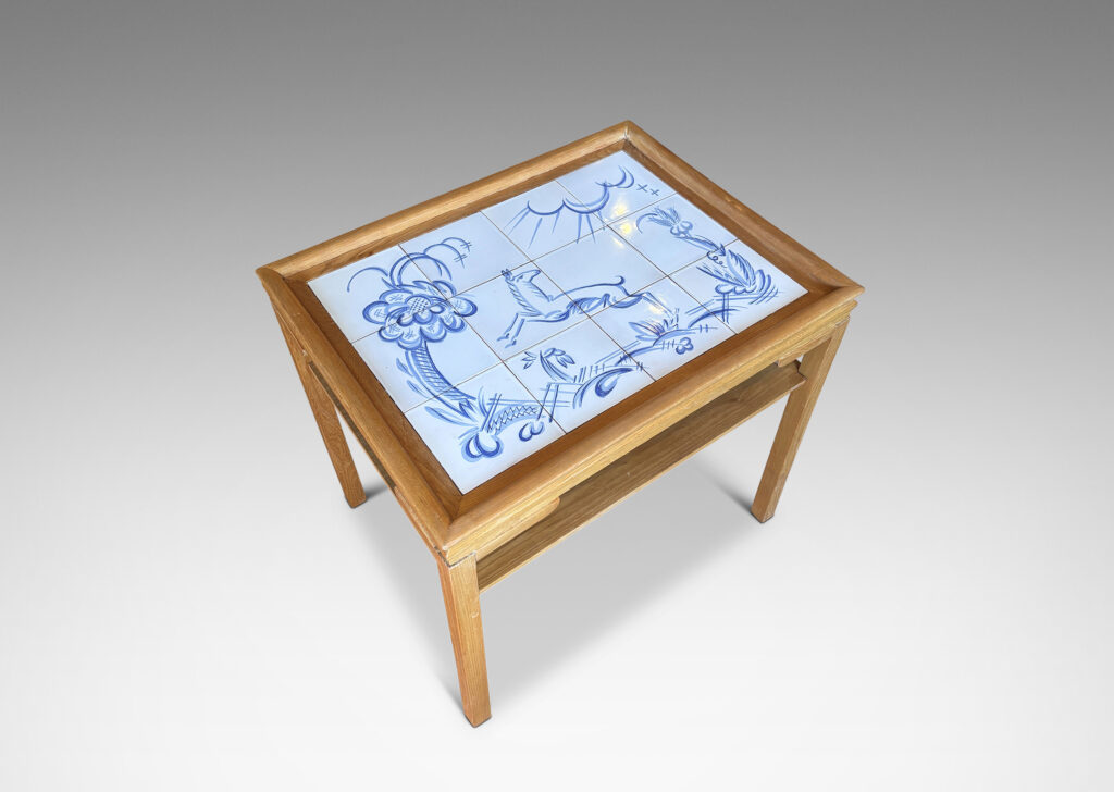 Gallery BAC rectangular top with sculpted lip, tapered legs and shelf, featuring a tile top surface in white glaze with charming hand-painted deer and landscape design in blue