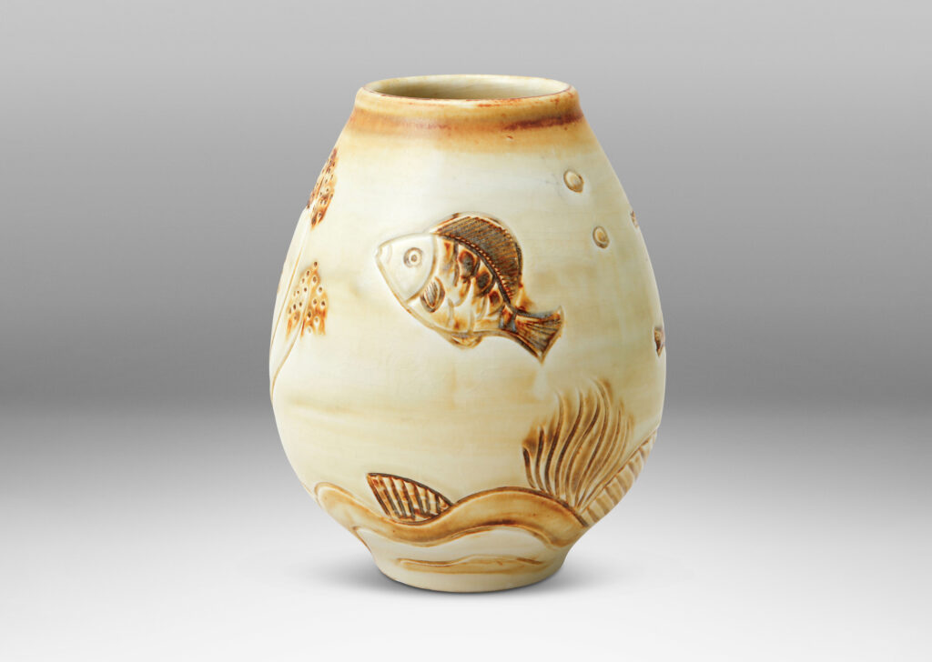 Gallery BAC tulip form with carved reliefs of goldfish and water flora, glazed in a thin amber-tan with brown accents