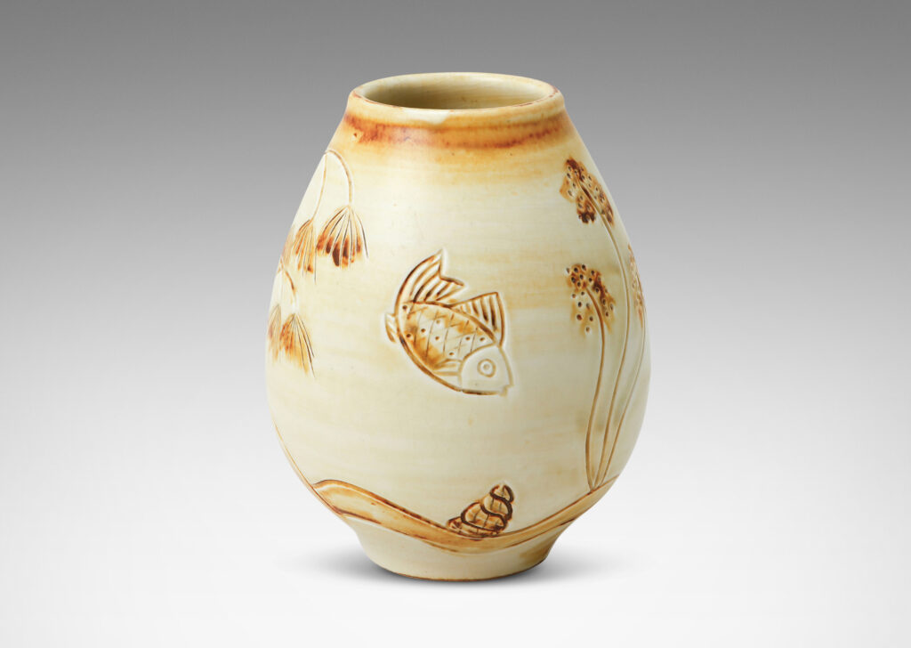 Gallery BAC tulip form with carved reliefs of goldfish and water flora, glazed in a thin amber-tan with brown accents