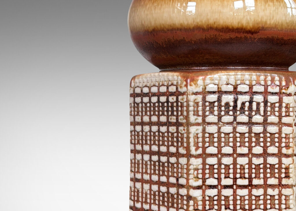 Gallery BAC hexagonal forms with gridded textural reliefs and bun-shaped caps, glazed in brown over ivory