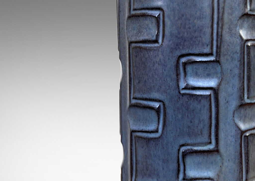 Gallery BAC tapered form with carved Greek key-like stripe design, glazed in gray-blue with black undertones
