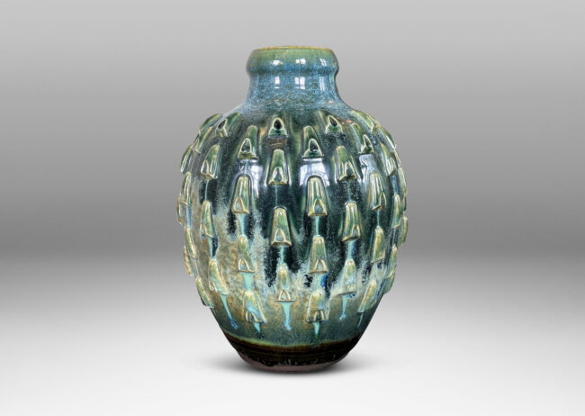 Gallery BAC tapered form with large neck and applied decorative cleats, glazed in flowing olive and teal green glazing