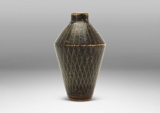 Gallery BAC angled tapered vase with carved radial lines and diamond pattern, glazed in gray-black