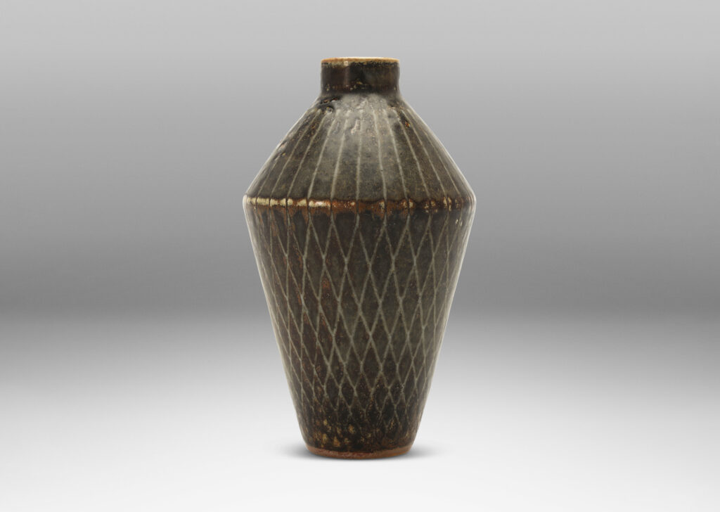 Gallery BAC angled tapered vase with carved radial lines and diamond pattern, glazed in gray-black