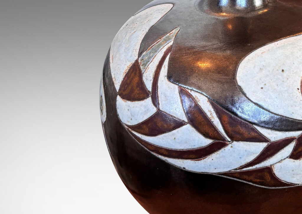 Gallery BAC arge apple-like form with carved free-form band of birds and shapes, glazed in a dark brown luster