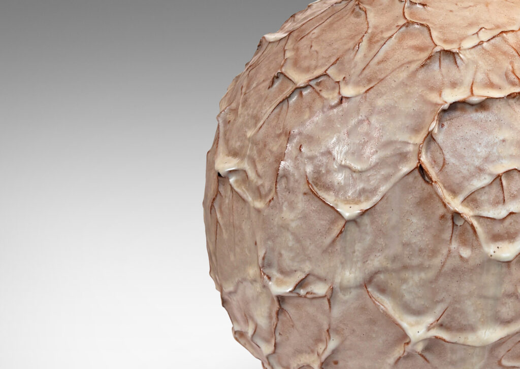 Gallery BAC highly textured globe form glazed in beige with brown tinted edges