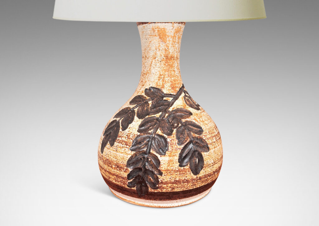 Gallery BAC swelling form with flared neck, with grog texture and carved foliate design, glazed in a pale golden beige with medium brown dry brush striae texture and dark brown decoration