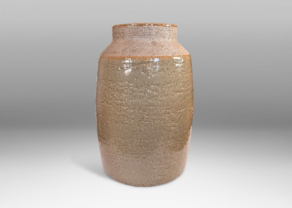 Gallery BAC swelling cylindrical form with angled shoulder and wide cuff mouth in grog ceramic with partial gloss greenish gray gloss