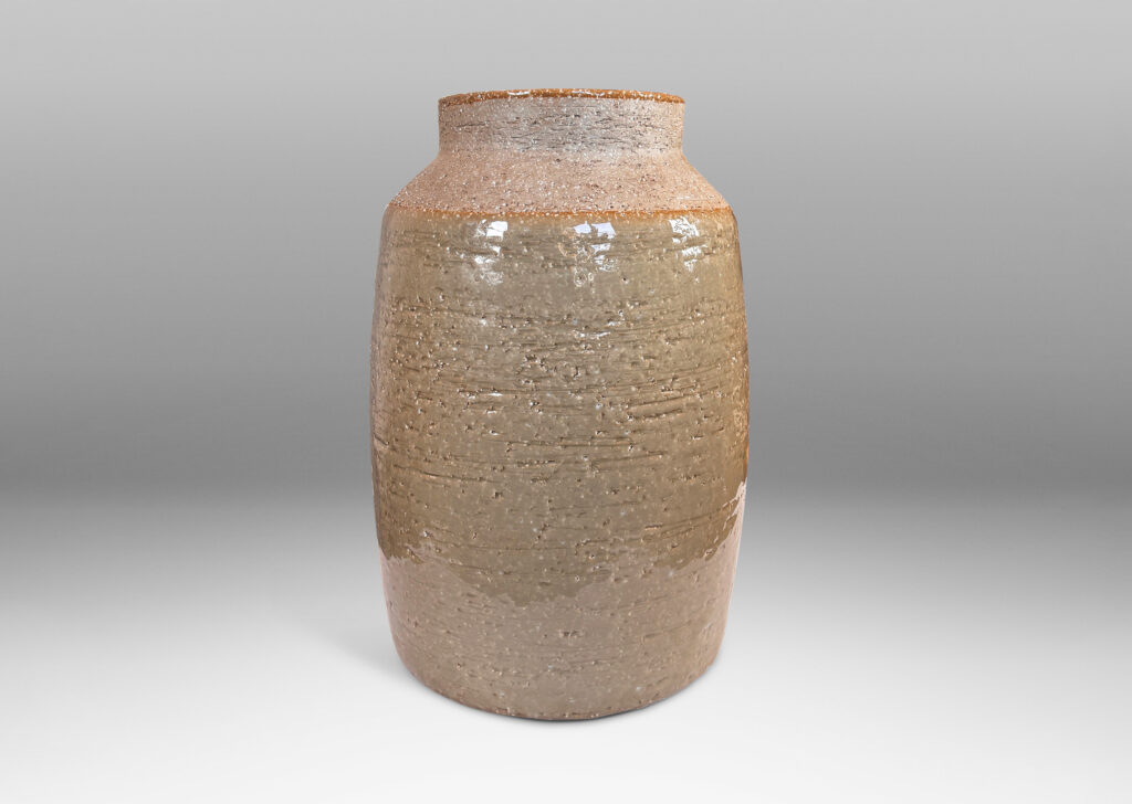 Gallery BAC swelling cylindrical form with angled shoulder and wide cuff mouth in grog ceramic with partial gloss greenish gray gloss