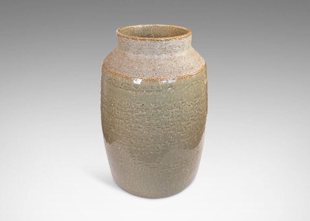 Gallery BAC swelling cylindrical form with angled shoulder and wide cuff mouth in grog ceramic with partial gloss greenish gray gloss