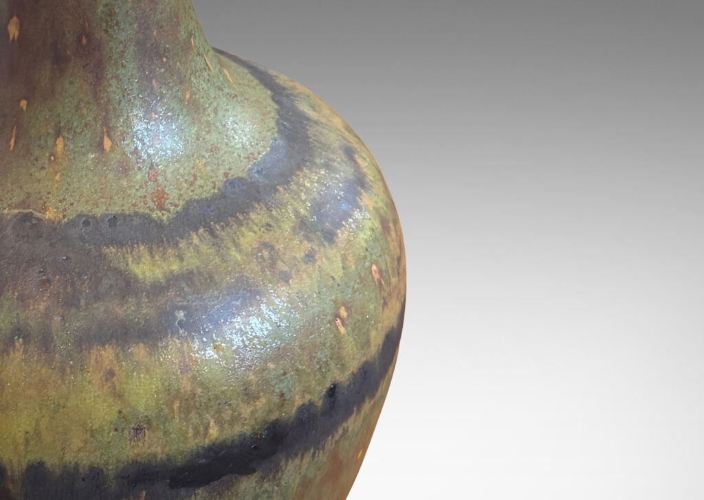 Gallery BAC bulbous form and tall sprouting neck, glazed in a medium brown with green undertones and watery dark brown stripes