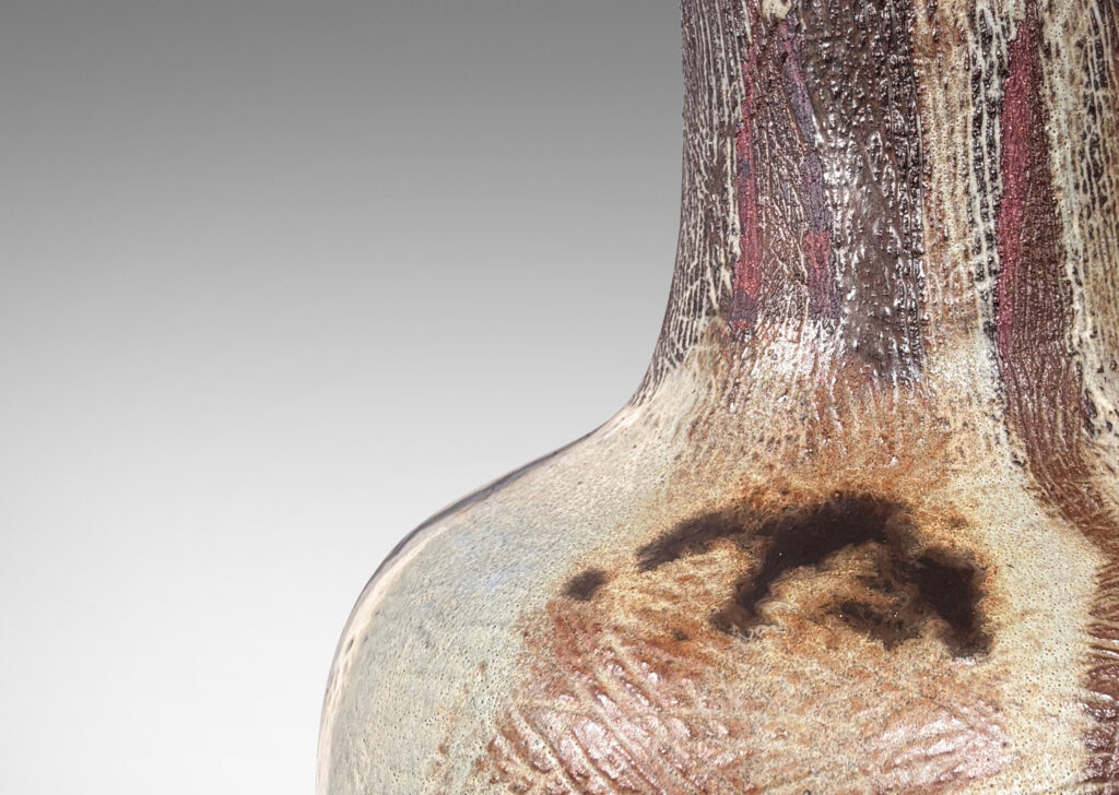 Gallery BAC low drum form and wide neck, with carved hatched texture and flowing brown and pale gray glazing