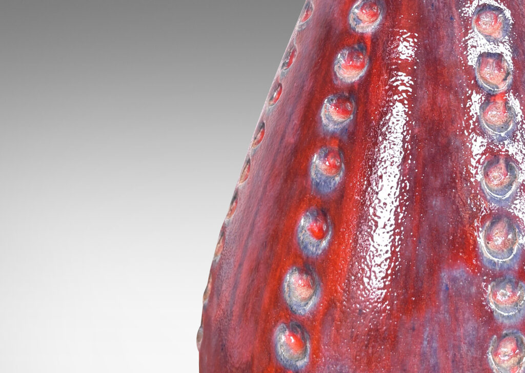 Gallery BAC echinoderm-evoking drop form with meridians of carved dots, glazed in shiny burgundy and light purple