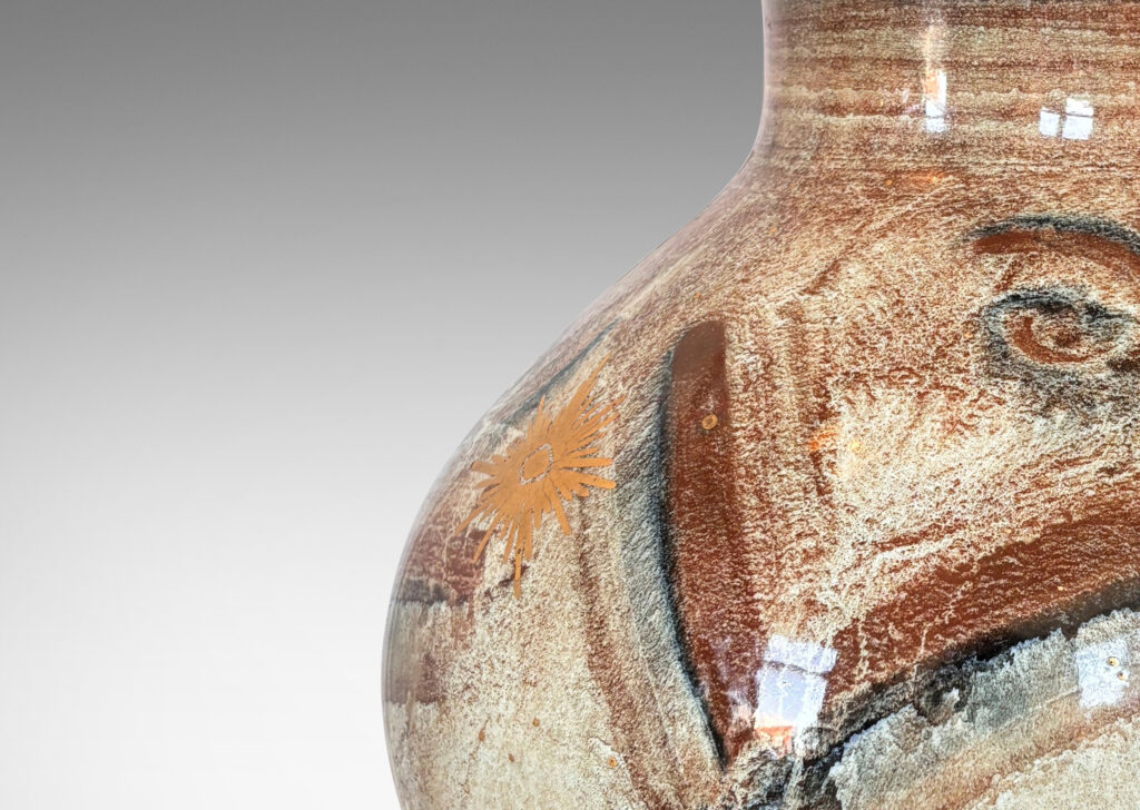 Gallery BAC plump globe form with short wide neck, glazed in pale greige, with chevron pattern in browns and blacks, and gilded star motifs and accents