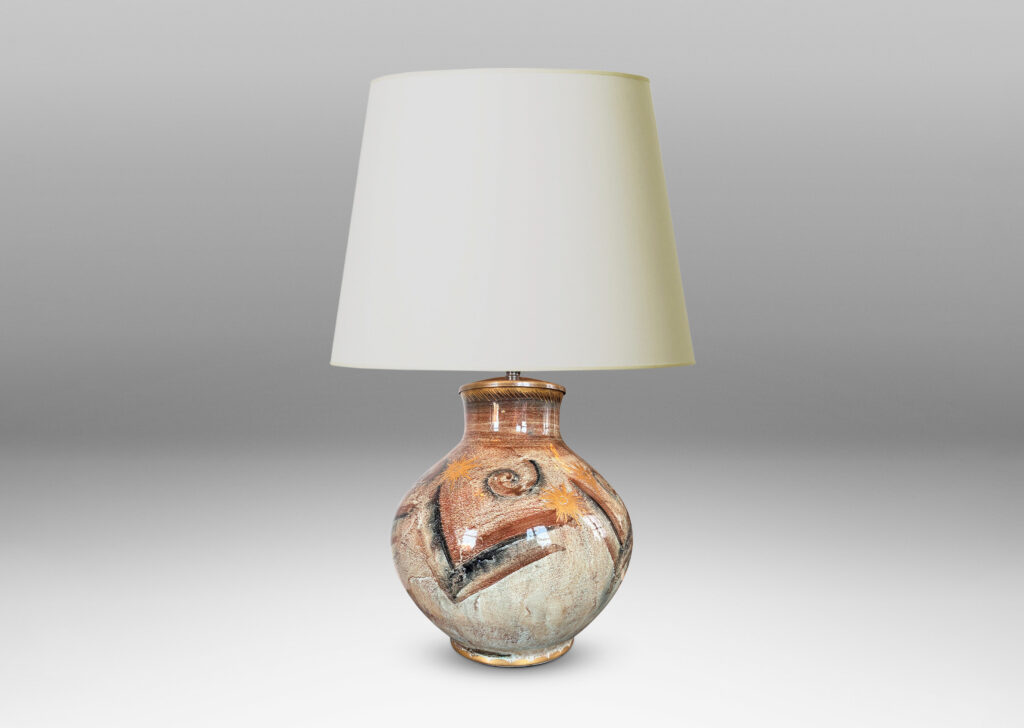 Gallery BAC plump globe form with short wide neck, glazed in pale greige, with chevron pattern in browns and blacks, and gilded star motifs and accents