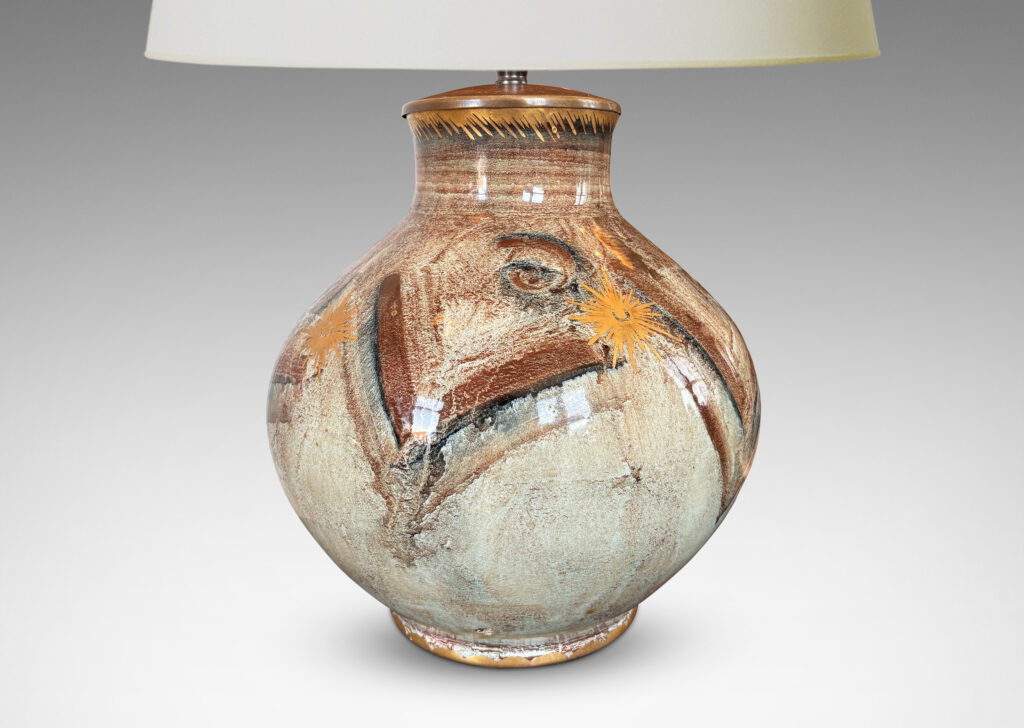 Gallery BAC plump globe form with short wide neck, glazed in pale greige, with chevron pattern in browns and blacks, and gilded star motifs and accents